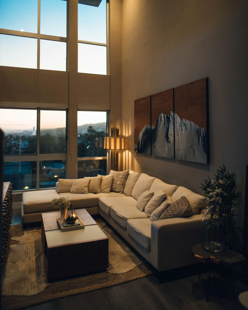 gray padded chaise couch beside window